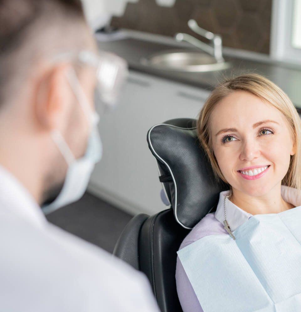 woman speaking to a dentist