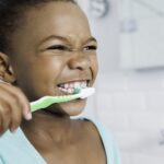 young girl brushing to prevent cavities in children